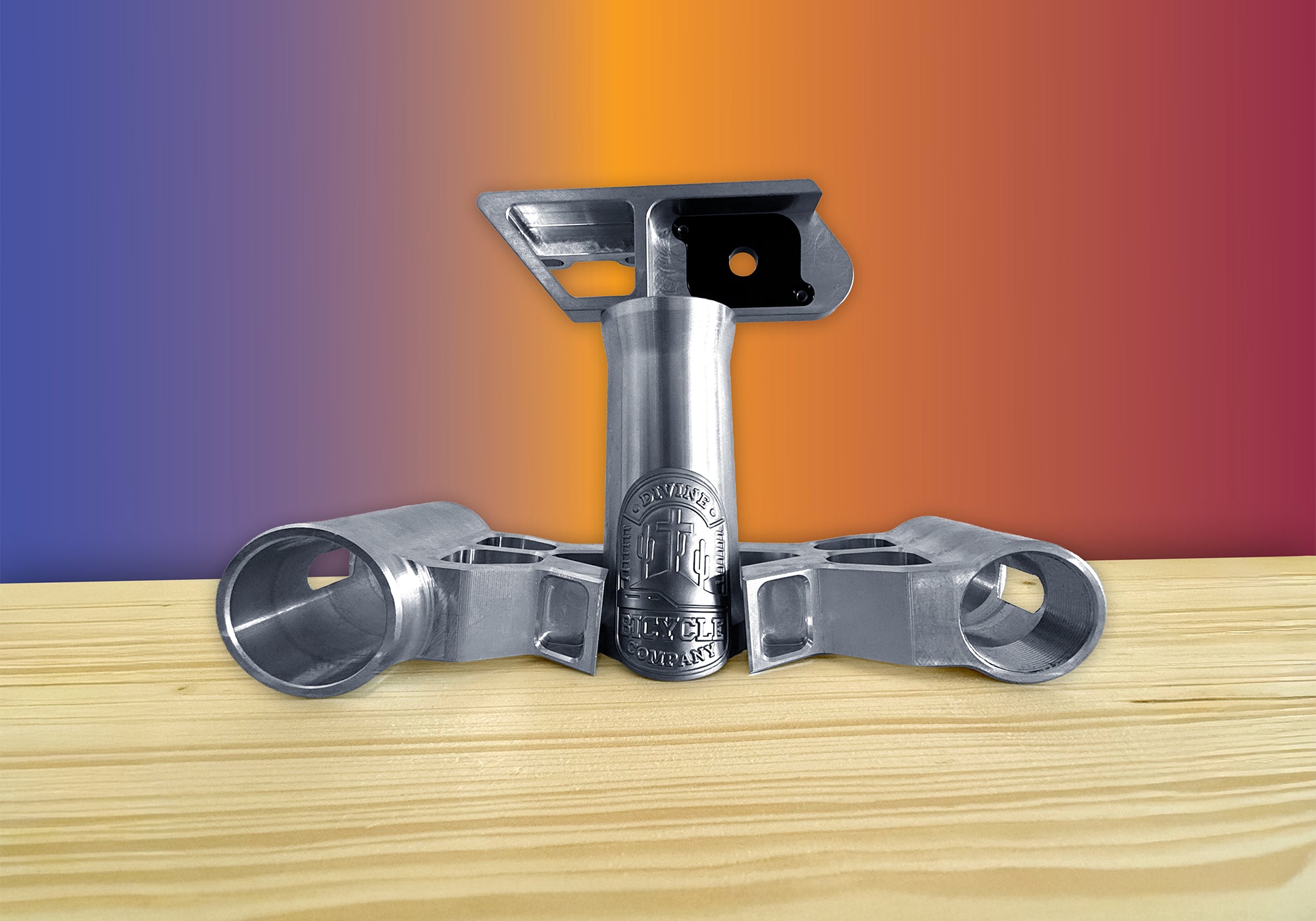 Divine BMX bike parts stacked on a table, showcasing CNC-machined precision.
